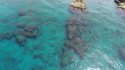 Stand up paddle board area. Best place for summer sports. Beautiful aerial shot of the ocean. Summer theme. Explore the ocean. People paddle boarding. Calm sea and waves. Sunny hot day. Top view