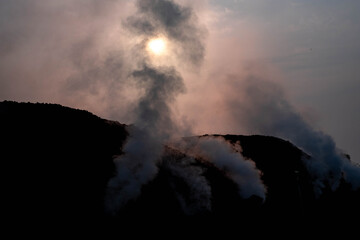 Folk wisdom charcoal kilns, for everyday use where the logs are arranged in layers, then used clay to cover the fire and drill holes to create air vents, possibly causing the pm2.5 dust problem