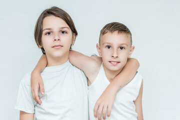 children smiling stand embracing and posing 