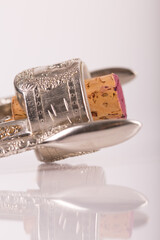 Red wine bottle, cork stopper and an italian prestigious corkscrew on a white background