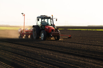 Farmer with tractor seeding