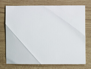 Sheet of paper on wood background