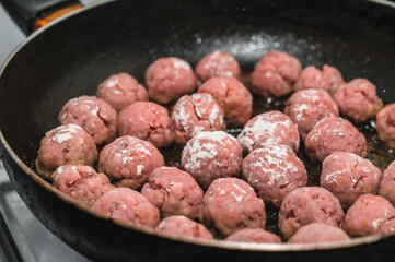 Meat balls are fried in a frying pan in oil. The cooking process. Delicious food.