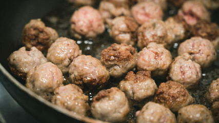 Meat balls are fried in a frying pan in oil. The cooking process. Delicious food.
