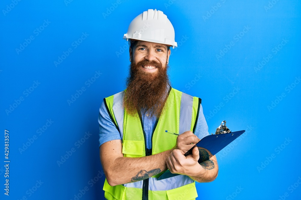 Canvas Prints redhead man with long beard wearing safety helmet holding clipboard smiling with a happy and cool sm