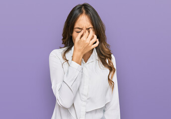 Young brunette woman wearing casual clothes tired rubbing nose and eyes feeling fatigue and headache. stress and frustration concept.