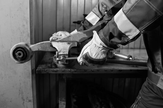 man hands in protective gloves working on a machine