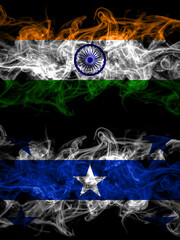 India, Indian vs Gambier Islands smoky mystic flags placed side by side. Thick colored silky abstract smoke flags.