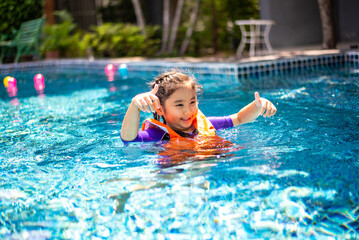 An Asian little girl in the swimming pool