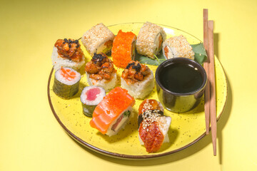Sushi rolls on yellow background