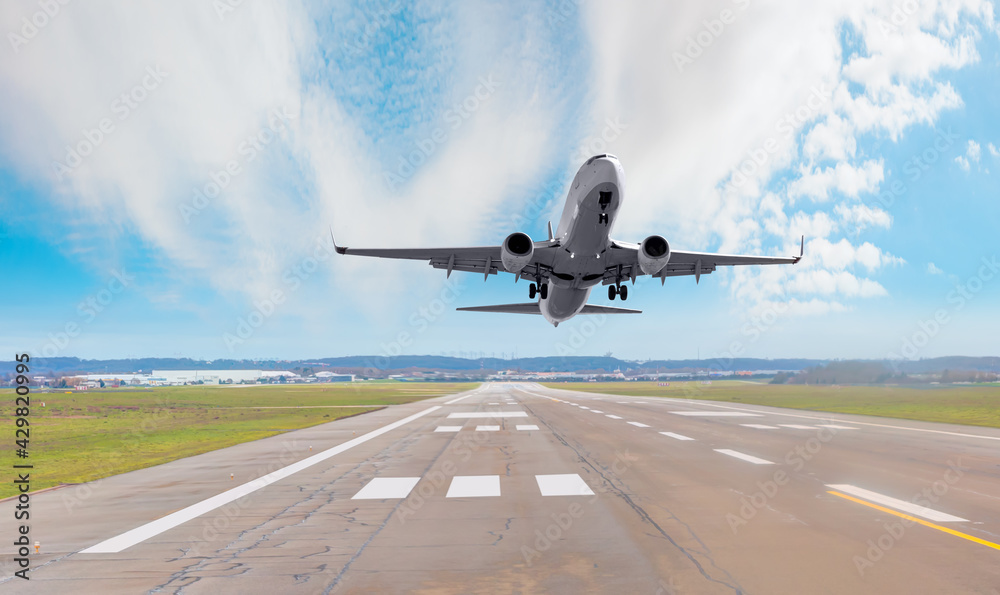 Wall mural White Passenger plane fly up over take-off runway from airport 