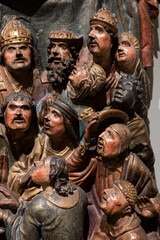 Crowd of people faces watching, handmade wooden sculpture