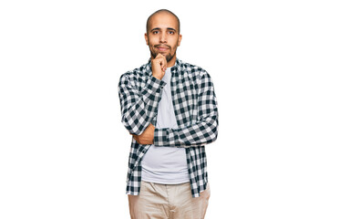 Fototapeta premium Hispanic adult man wearing casual clothes looking confident at the camera with smile with crossed arms and hand raised on chin. thinking positive.