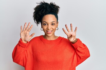Young african american girl wearing casual clothes showing and pointing up with fingers number nine...