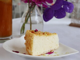 cake in the plate of heart with drink and orchids design for elegant afternoon tea time