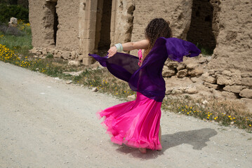 Woman dance belly oriental dancing in coloured costume outdoor. Dance in the street
