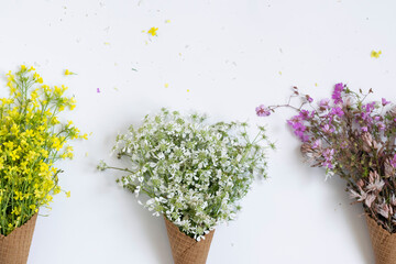 Waffle ice cream cones filled with fresh blossom wild flowers