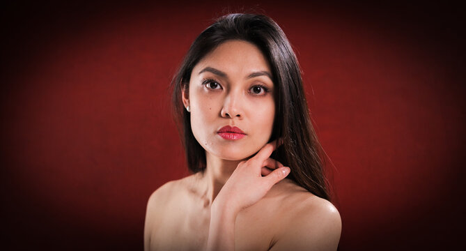 Pretty young woman with bare shoulder and torso - studio photography