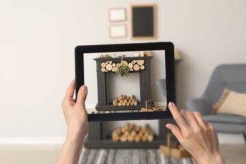Woman taking photo of fireplace in room