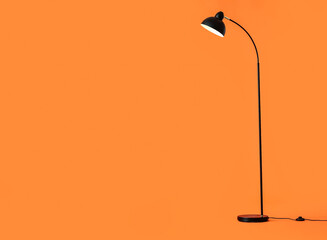 Modern floor lamp on color background