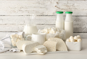 Different dairy products on light wooden background