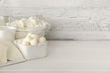 Different dairy products on light wooden background