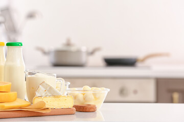 Different dairy products on table in kitchen