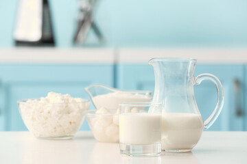 Different dairy products on table in kitchen