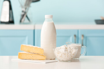 Different dairy products on table in kitchen