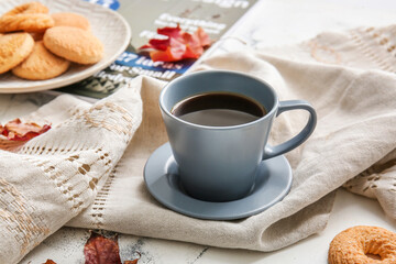 Beautiful autumn composition with cup of coffee and cookies on light background