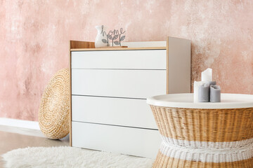 Chest of drawers and table in stylish room