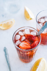 Fresh beverage with strawberry and lemon on the table. Summer refreshing drink