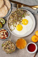 Healthy breakfast with egg, bean sprouts, fruit, honey and juice. Top view. Flat lay
