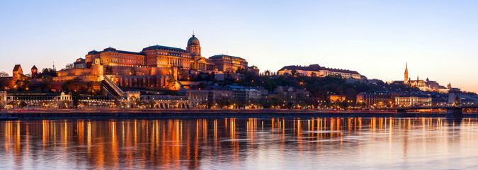Fototapeta na wymiar Hungary, Budapest at night, Buda Fortress illuminated by lights, reflected in the water, panorama