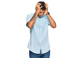Young handsome african american man wearing casual clothes suffering from headache desperate and stressed because pain and migraine. hands on head.