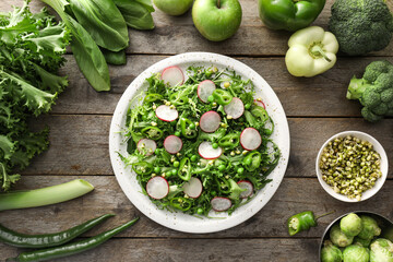 Plate of tasty salad with fresh vegetables on wooden background