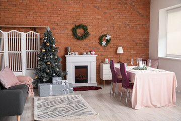 Interior of dining room with Christmas tree and fireplace
