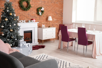 Interior of dining room with Christmas tree and fireplace