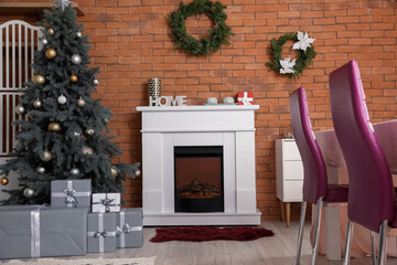 Interior of dining room with Christmas tree and fireplace