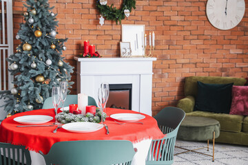 Interior of dining room with Christmas tree and fireplace