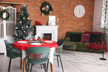 Interior of dining room with Christmas tree and fireplace