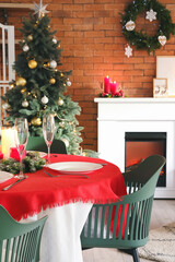 Interior of dining room with Christmas tree and fireplace