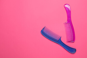 Plastic hair combs on color background