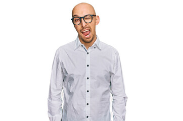 Bald man with beard wearing business shirt and glasses winking looking at the camera with sexy expression, cheerful and happy face.