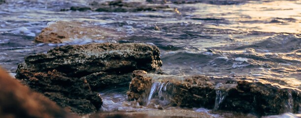 Blurred abstract natural background of sea water with waves and foam. Motion blur. Nature. Banner.	