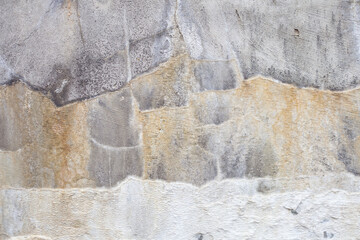 Fototapeta premium Concrete wall with divorces in the form of stripes of yellow and white. Interesting background