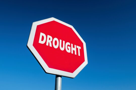 Traffic sign with the text DROUGHT to stop global warming, climate changes and dryness