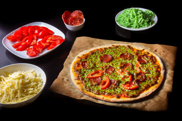 Hot pizza with green cheese and ingredients