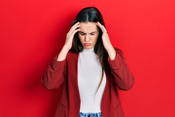 Young brunette teenager wearing business jacket with hand on head for pain in head because stress....