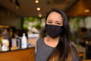 Face of woman wearing medical face mask for protection against coronavirus Covid-19